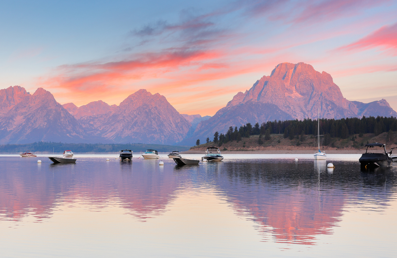 boats out on the river with mountains in the background - summer activities in Jackson Hole