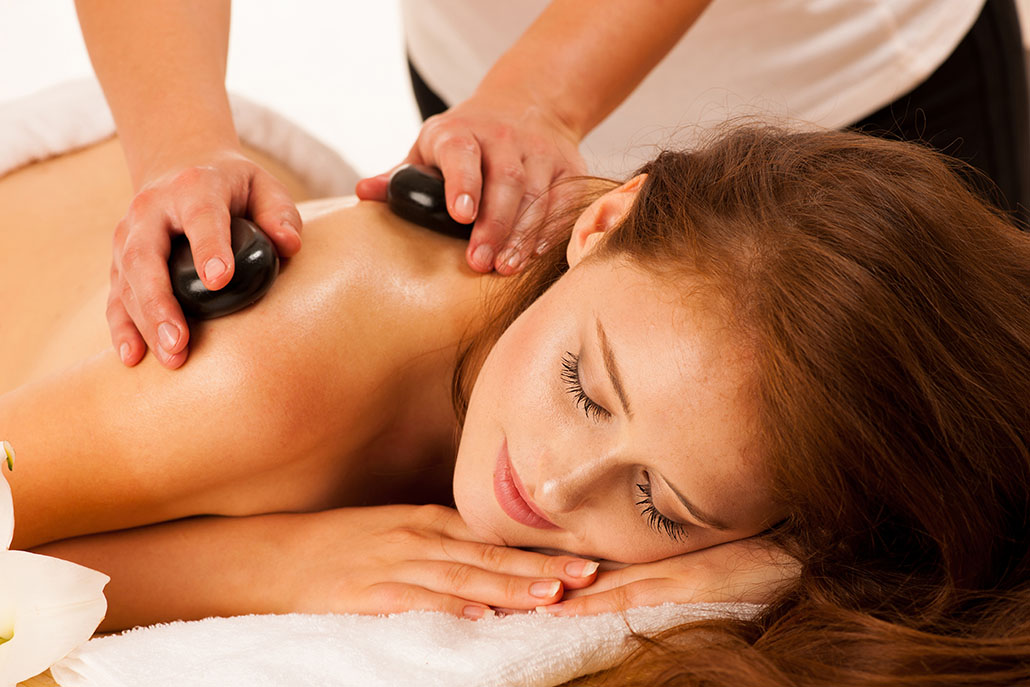 Stone therapy. Woman getting a hot stone massage